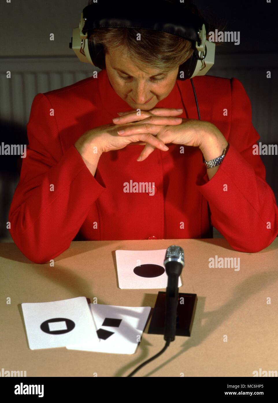 Testing psychometry. Messages are passed by audio systems. The designs are simple geometric figures or colour pictures,easy to describe verbally. Stock Photo