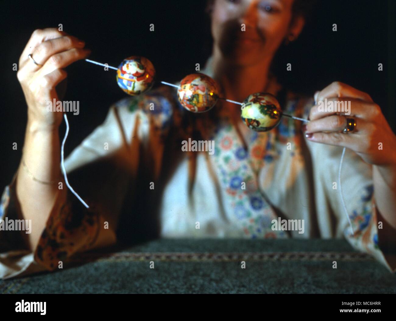 Stage Magic -Magic Balls. A piece of string and three balls are put into a hat. When the magcian lifts out the string, the balls are attached to it. Stock Photo