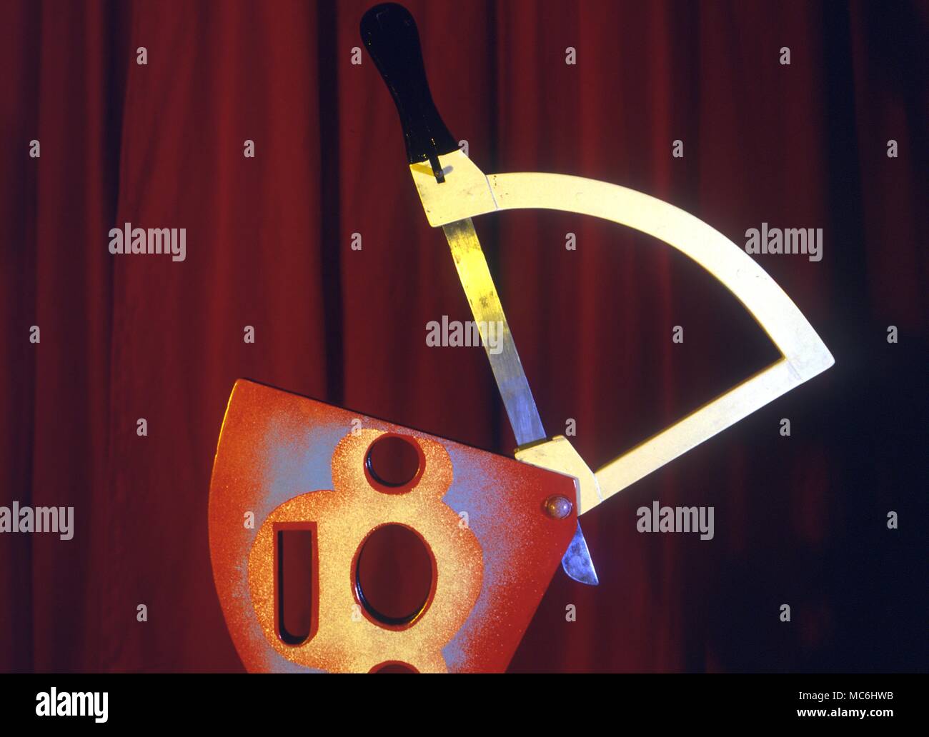 Stage Magic - Cutting off a girl's hand. How the guillotine looks without the blade retracted. Stock Photo