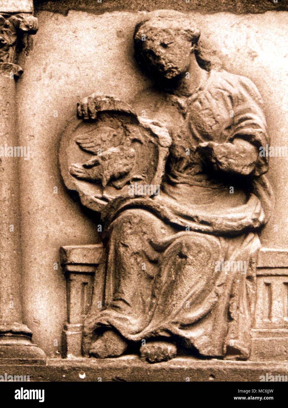 ALCHEMY - PUTREFACTION. Alchemical device of woman holding shield bearing a Crow, alchemical symbol of Putrefation. Thirteenth century relief on facade of Notre Dame, Paris Stock Photo