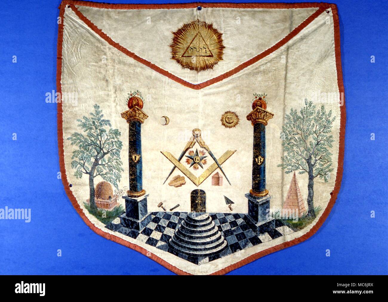 MASONIC APRON. The two pillars of Jachin and Boaz, painted on an early 19th century French lambskin apron. Note the pyramid, the hive and seven steps Stock Photo