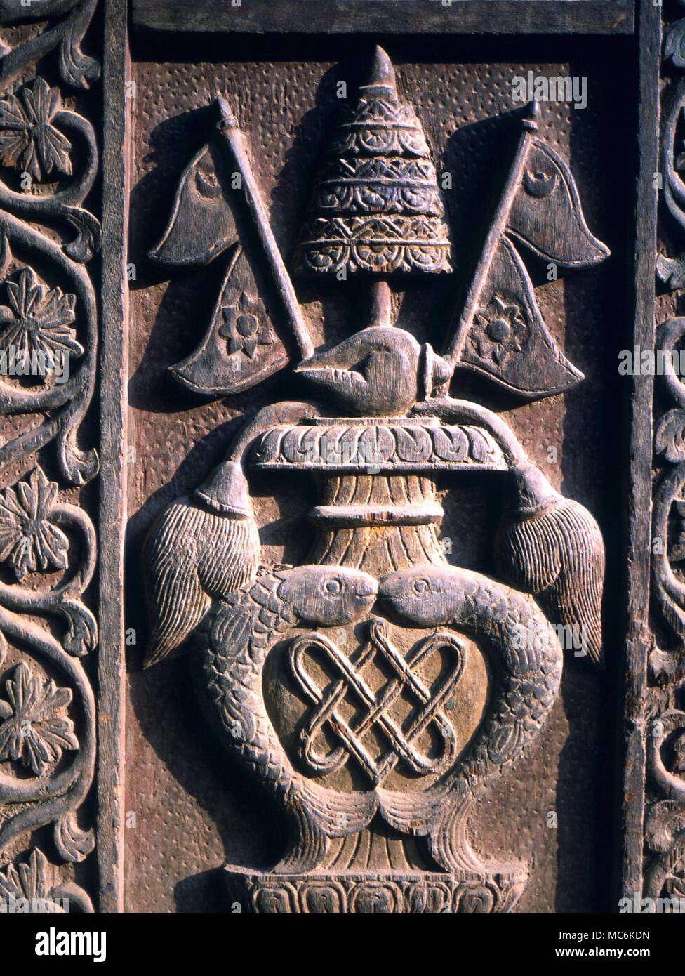 Buddhism Eight Sacred Symbols Wooden door panel with the eight sacred symbols of Buddhism Patan Nepal Stock Photo