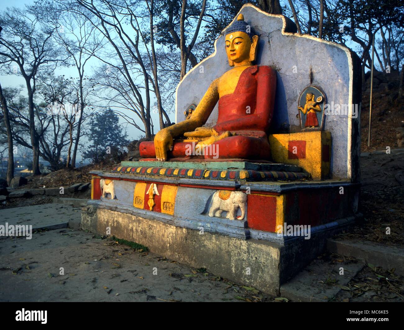 Buddhism Statue of Buddha with various symbols including the elephant symbols at the foot of the stairs leading to the Swayanbhunath Temple Nepal Stock Photo