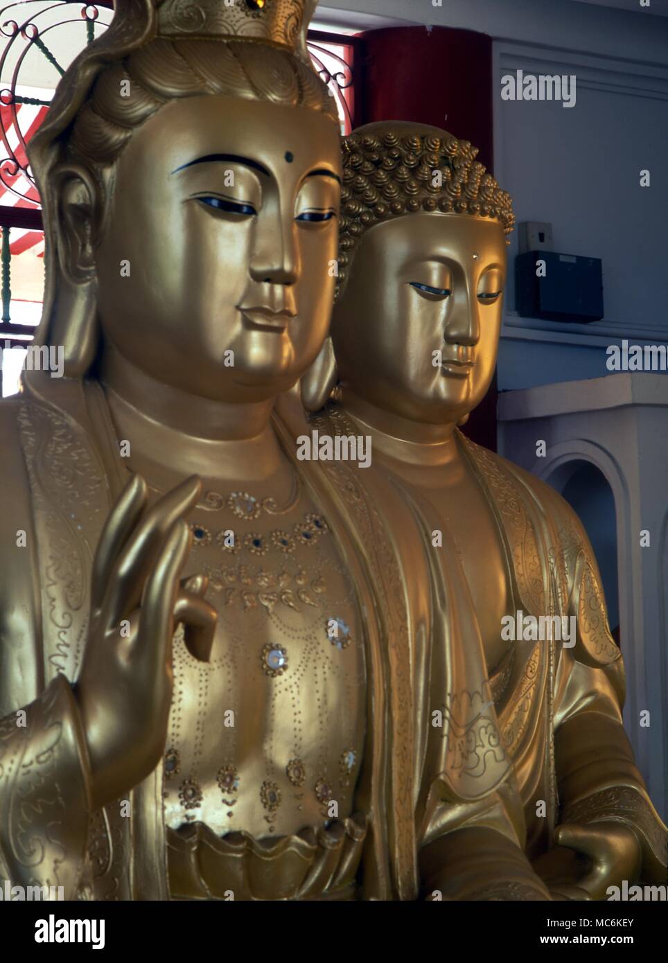 Buddhism Golden Buddhas (a pair from the three) in the upper chamber of