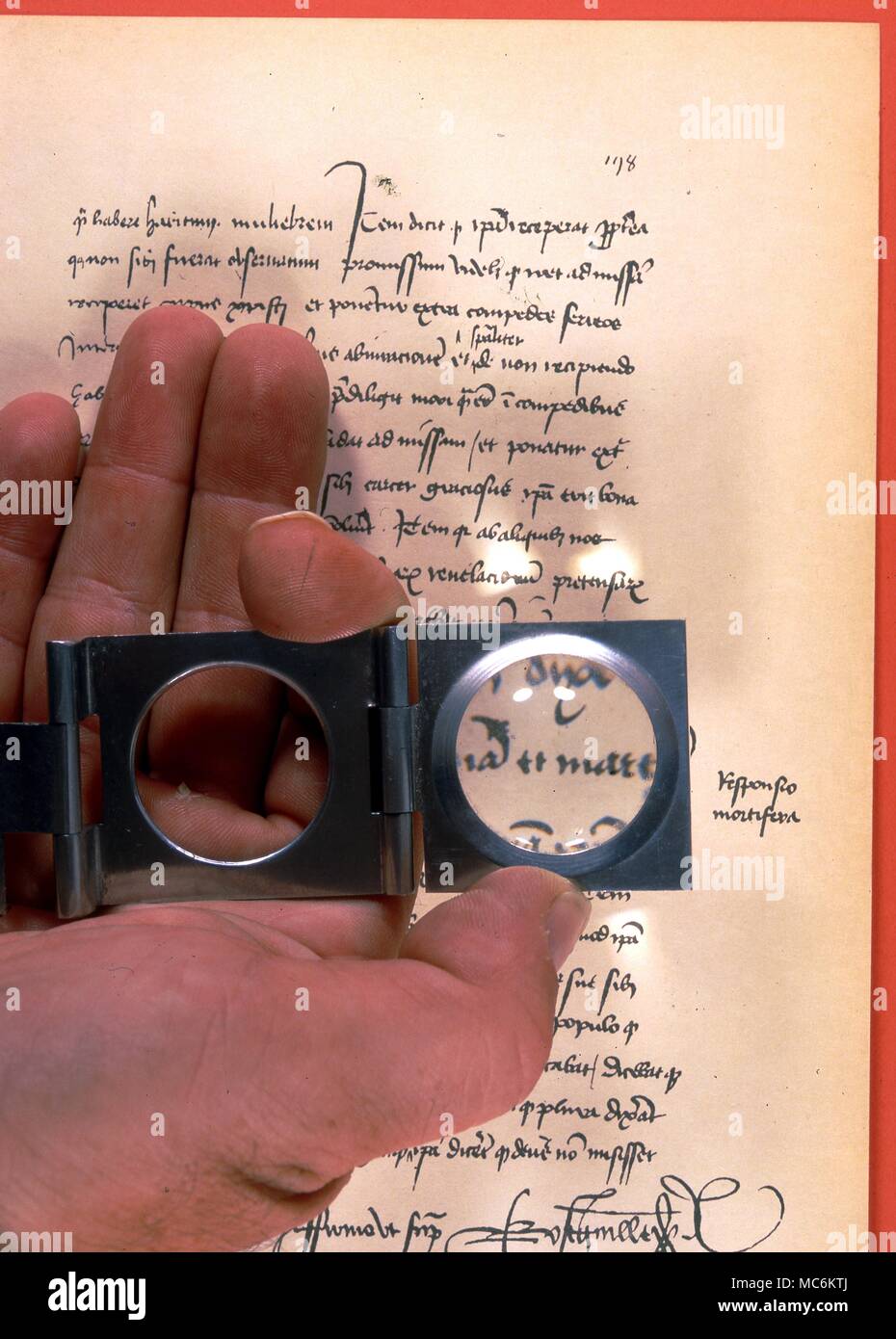 Graphology. Examining the handwriting on a court document from the trial of Joan of Arc, Stock Photo