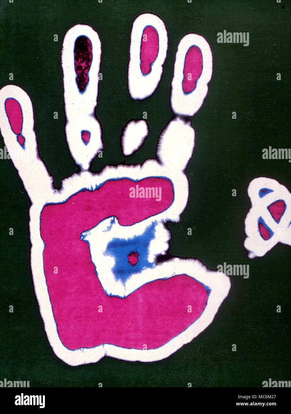 A Kirlian photo of a human hand, after it has been subjected to computerized colour treatment. Stock Photo