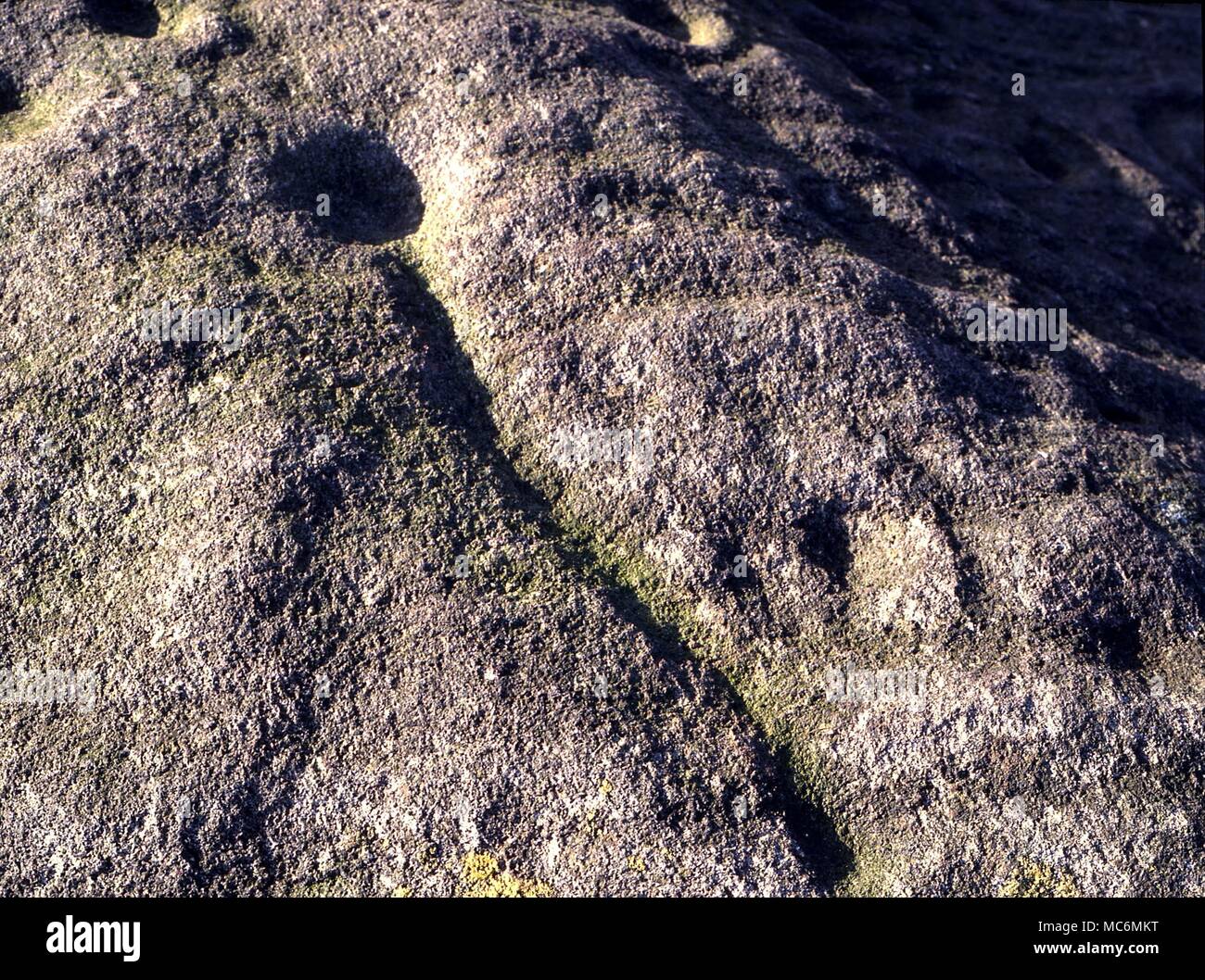 Ley Lines Cup and 'directional line' on the pancake stone, which is one of the loci in a complex of leys on Rombald's Moor, above Ilkley, Yorkshire. Stock Photo