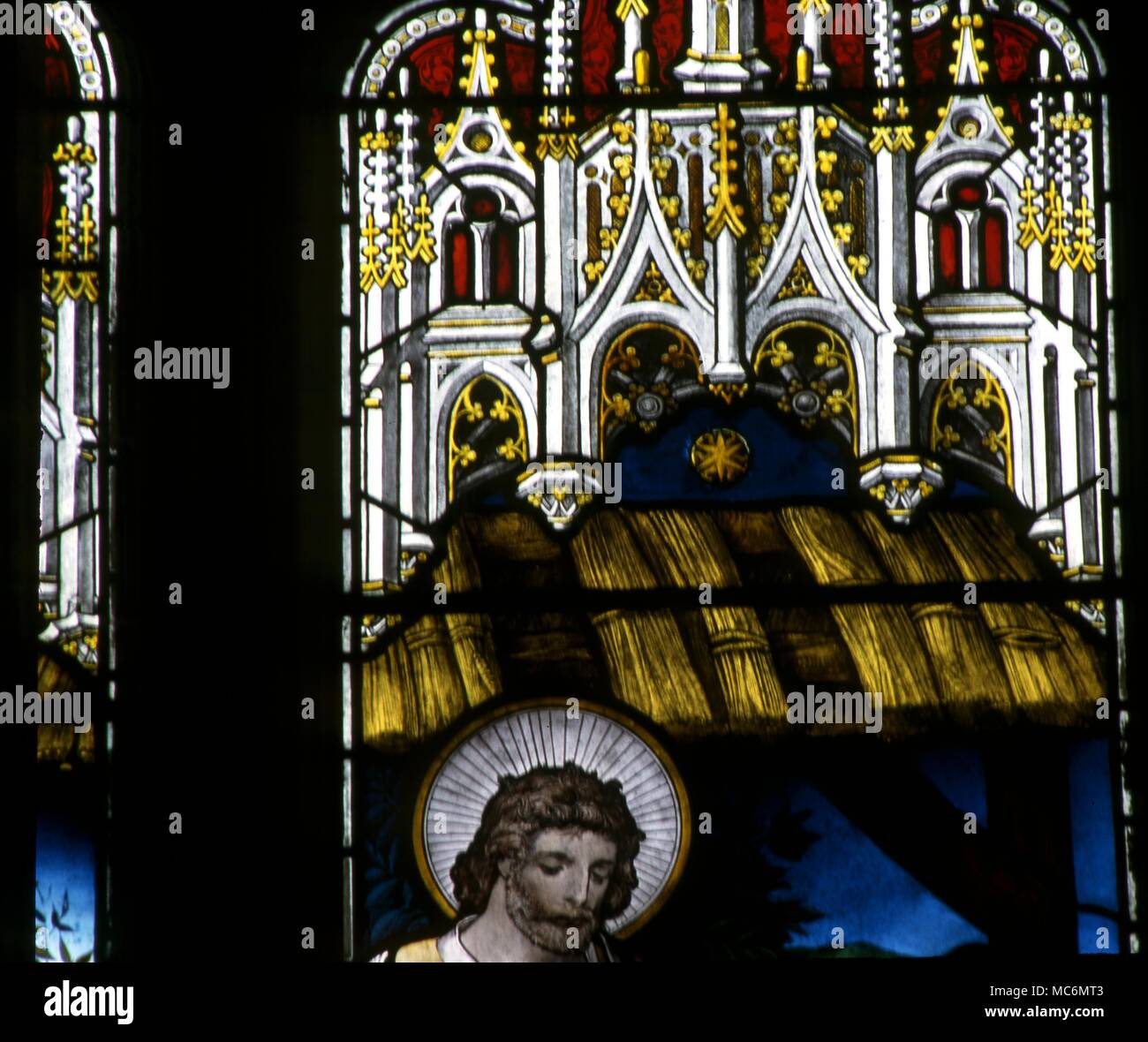 19th century stained glass window in the church of St Mary, Godstone, Surrey. A symbolic star over the manger. Stock Photo