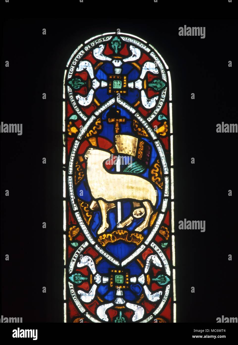 The Lamb of God in a Vesica Piscis. Stained glass window in Kilpeck church, near Hereford. Symbols - Vesica Piscis. The lamb of God in a Vesica Piscis. Stained glass window in Kilpeck church, near Hereford. Stock Photo