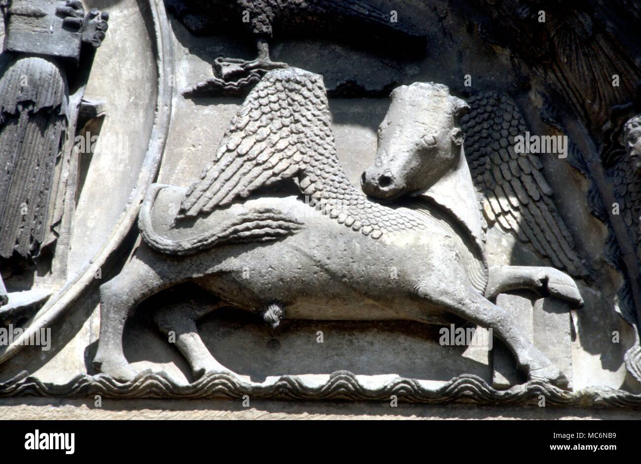 Ast. Sites Chartres The bull of Luke on the tympanum of the Royal Portal with the four zodiacal symbols for the Evangelists Chartres Cathedral 13th century Stock Photo