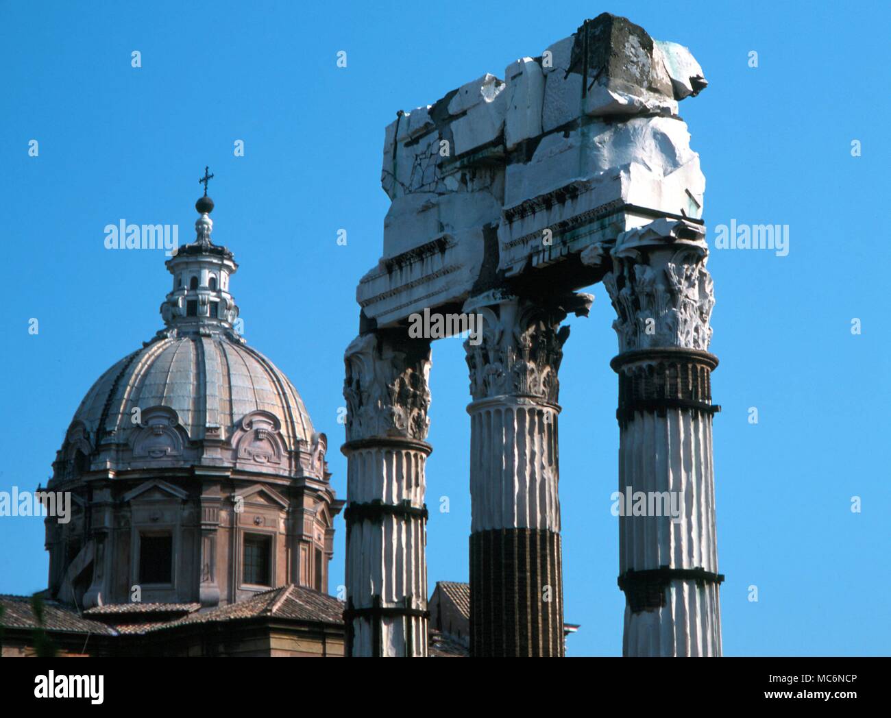 Italy Rome Forum of Caesar Detal of columns in the Forum of Caesar with the dome of SS Lucca and Martina Stock Photo