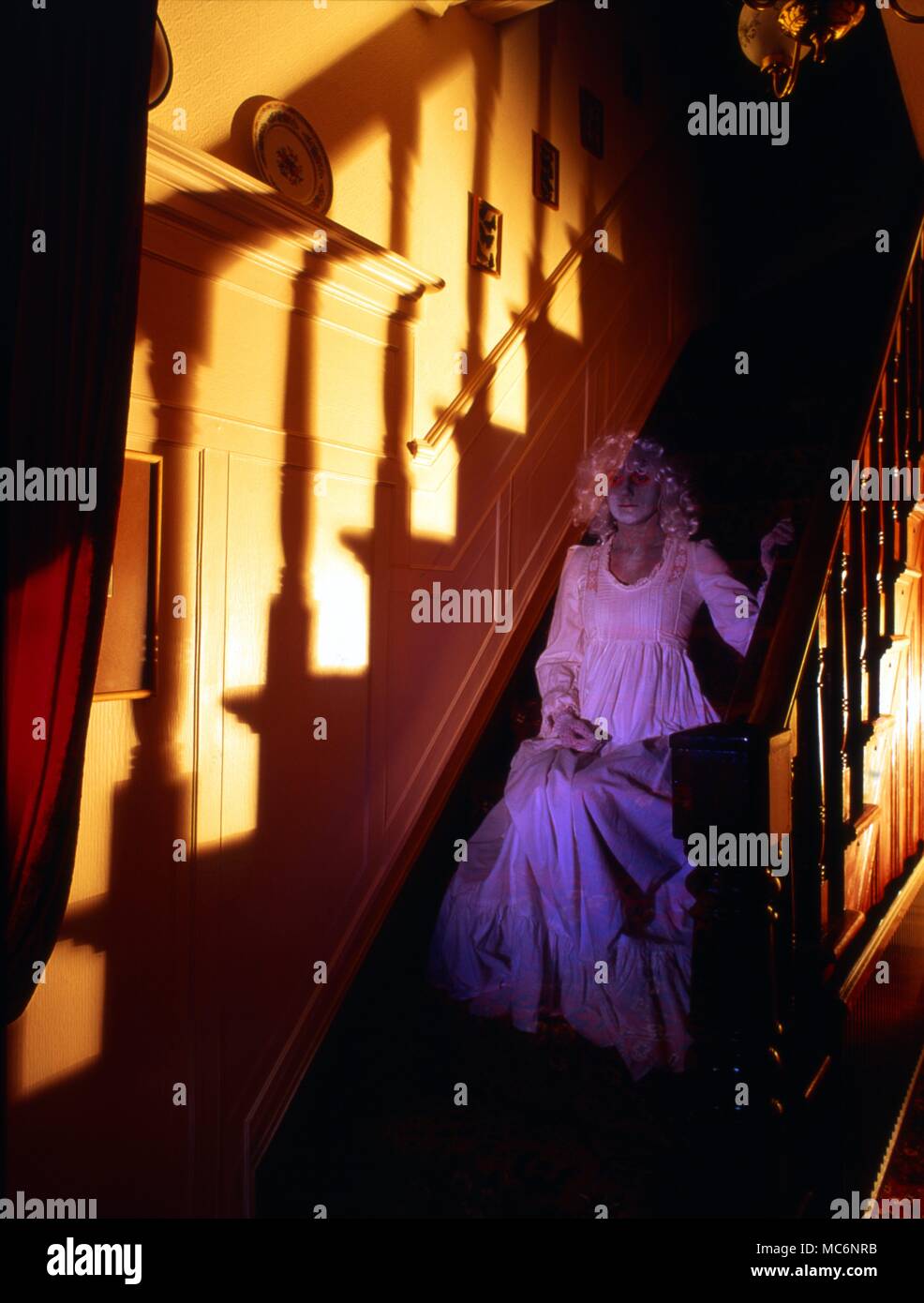 Ghostly woman, sitting on stairs. Stock Photo