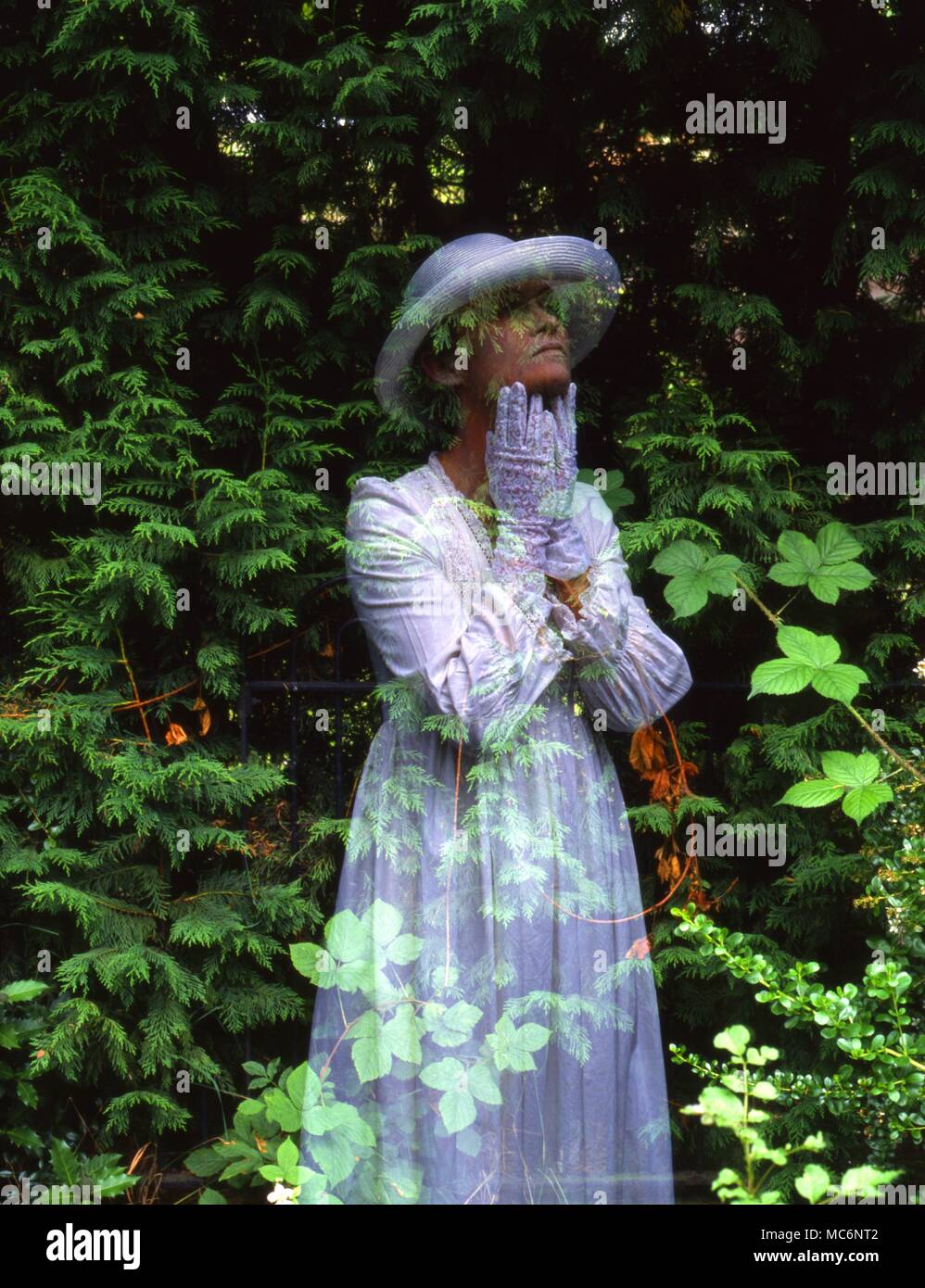 GHOSTS - HAUNTINGS - GHOST OF WOMAN IN GARDEN Stock Photo