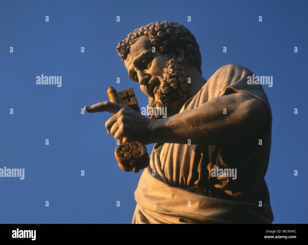 Saints - St Peter Saint Peter with the two keys to Heaven and Hell. Statue on the steps of the facade of St Peters, Rome Stock Photo