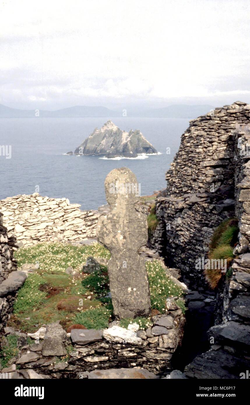 Christian The cross near the remains of the altar in the ruinous church on the Skellig Michael, off the coast of the West coast of Ireland Stock Photo