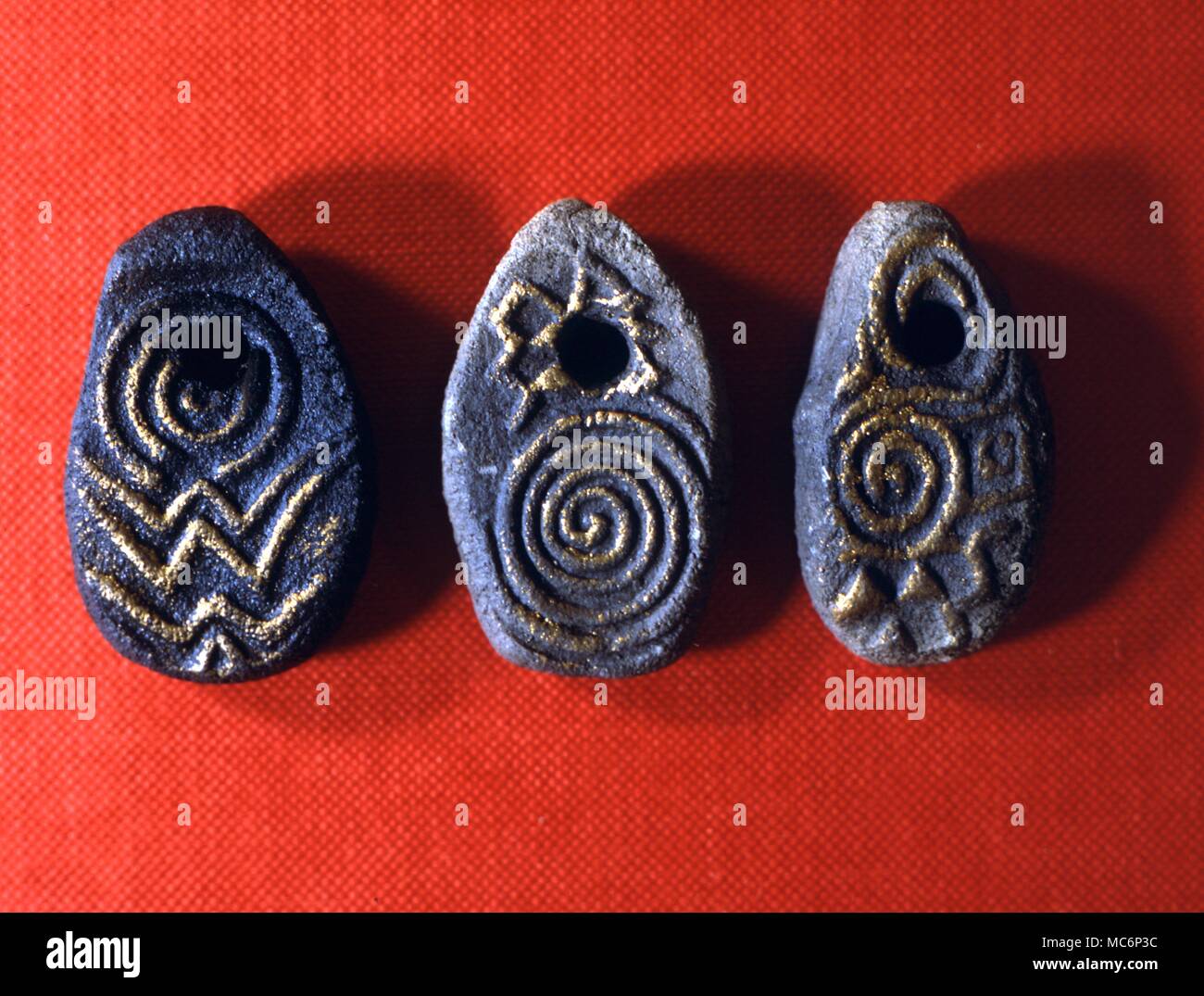 Sacred spiral stones used, among other things, for divination. The designs are based on ancient celtic carvings. Left: Water and kindness. Centre: Fire and confidence, sky energies fructifying the earth. Right: Fertility. 2004 Charles Walker / Stock Photo