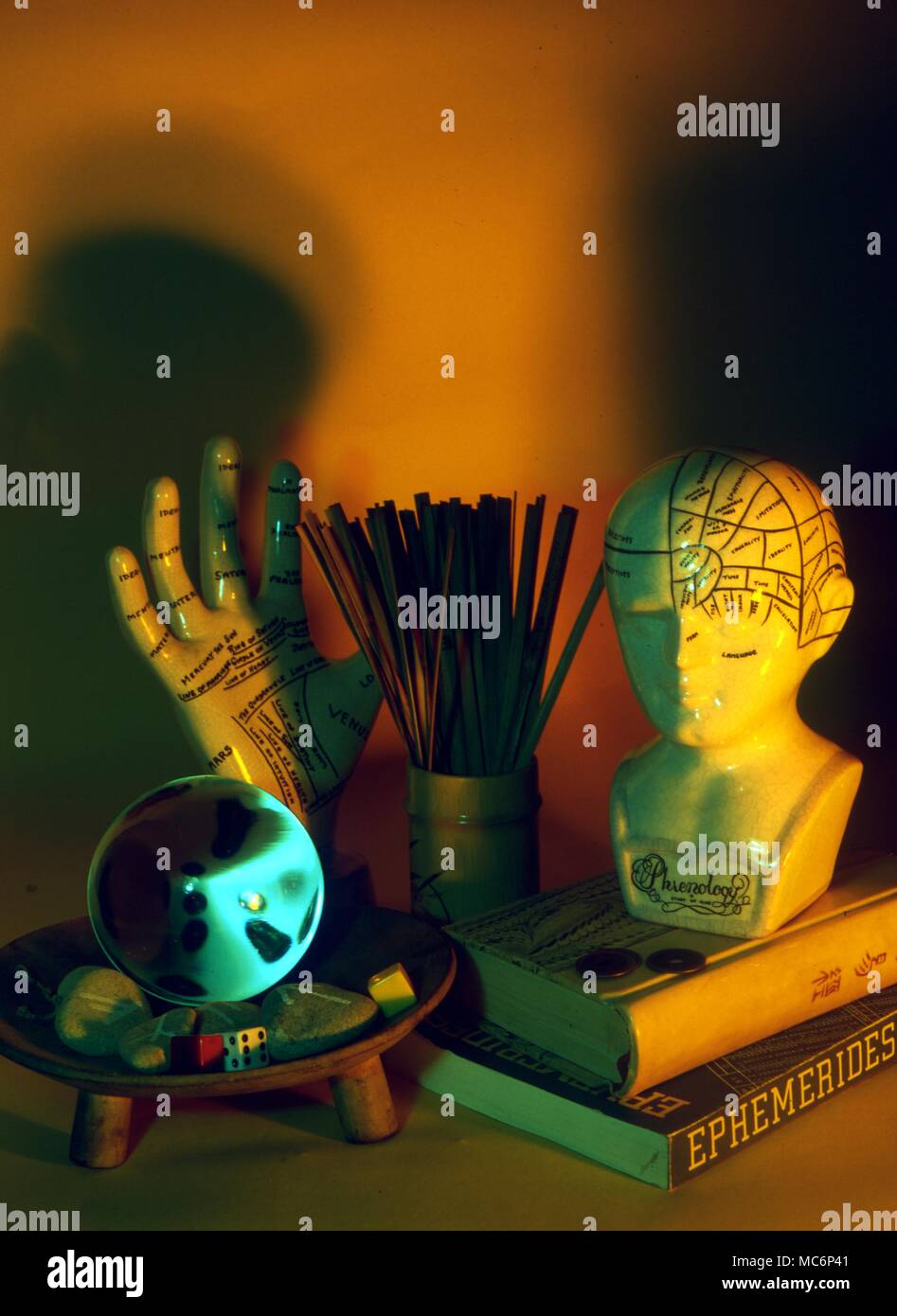 Various implements used in divination including I Ching sticks, a phrenology bust, a palmistry model, astrological books, dice, crystal, and so on. 2004 Charles Walker / Stock Photo