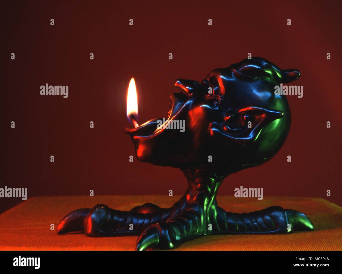 Lamp, designed for the use in both divination and rituals, designed by Graham Fenn-Edwards. The lamp wick feeds through the demonic tongue, into the lower jaw of the mouth. 2004 Charles Walker / Stock Photo