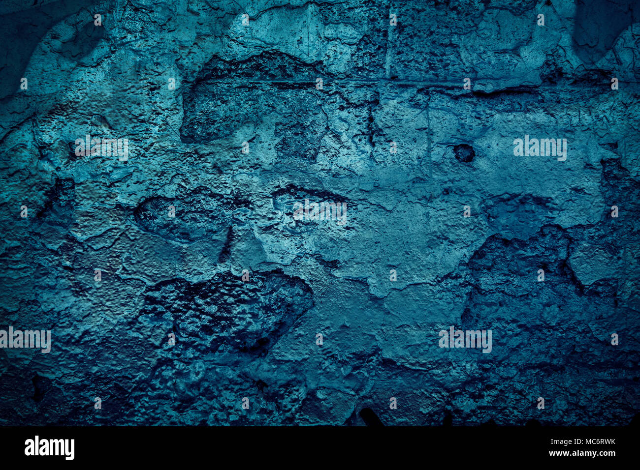 Grunge blue painted cracking wall concrete texture background. Stock Photo