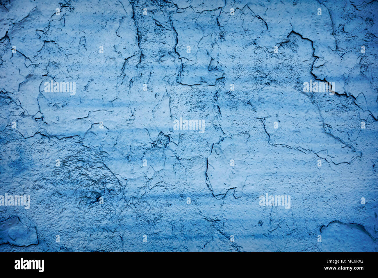 Blue painted cracking wall concrete texture background. Stock Photo