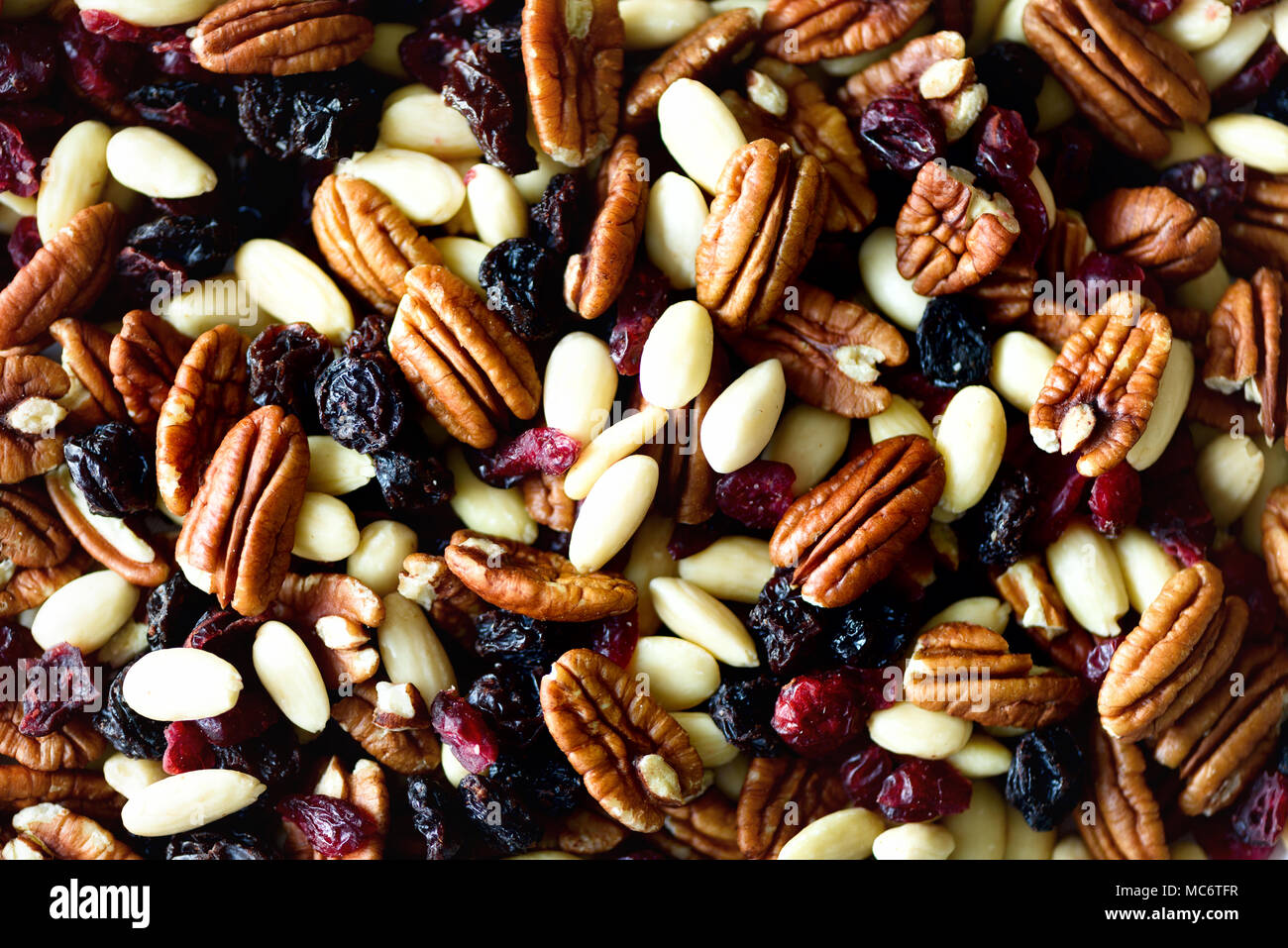 Mixed nuts and raisins in wooden bowl. Healthy food and snack. Walnut