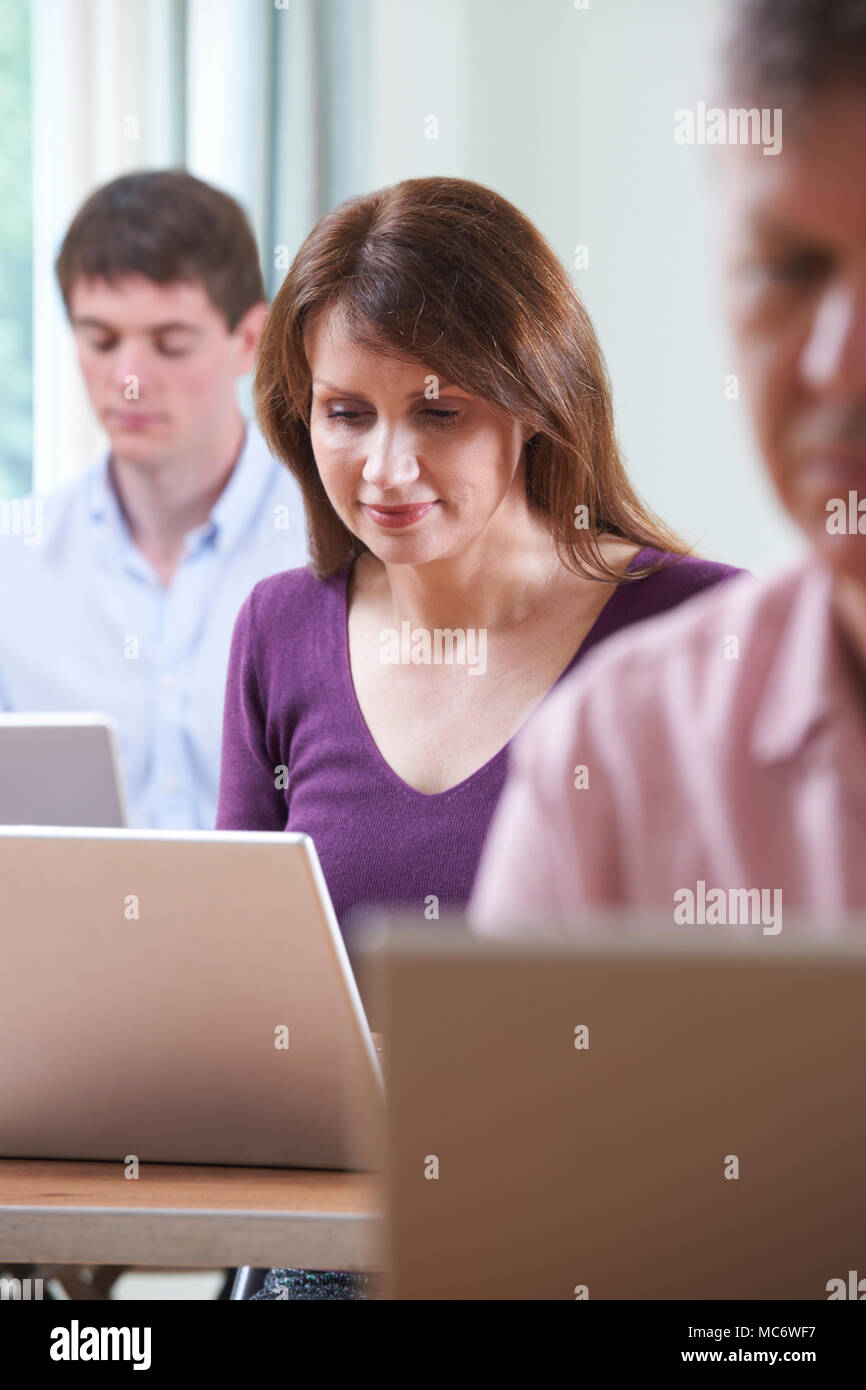 Female Mature Student In Adult Education Computer Class Stock Photo