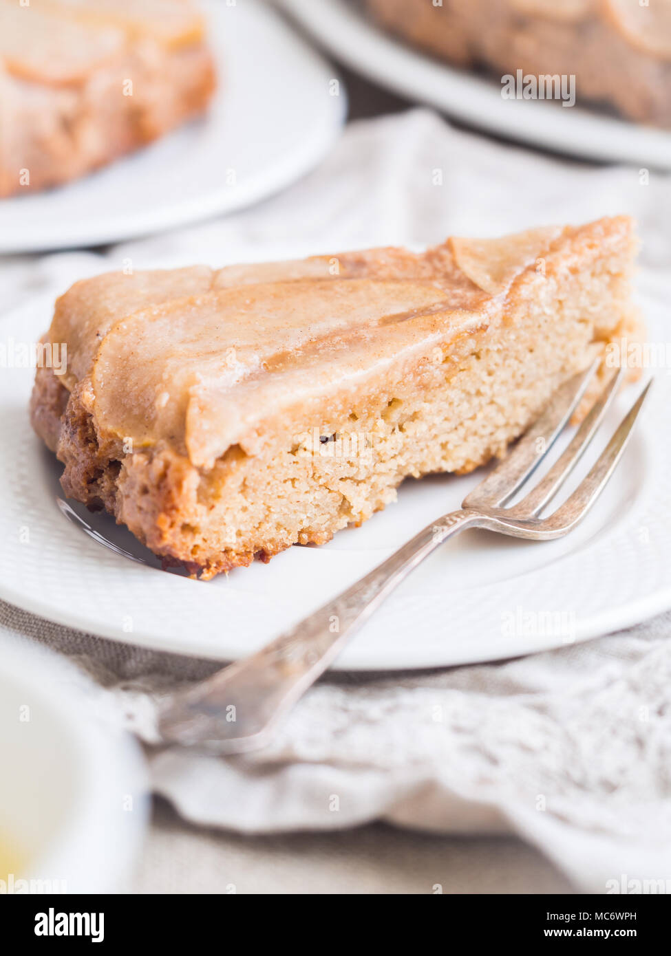 Slice of rustic upside down gluten and sugar free paleo pear cake. Stock Photo
