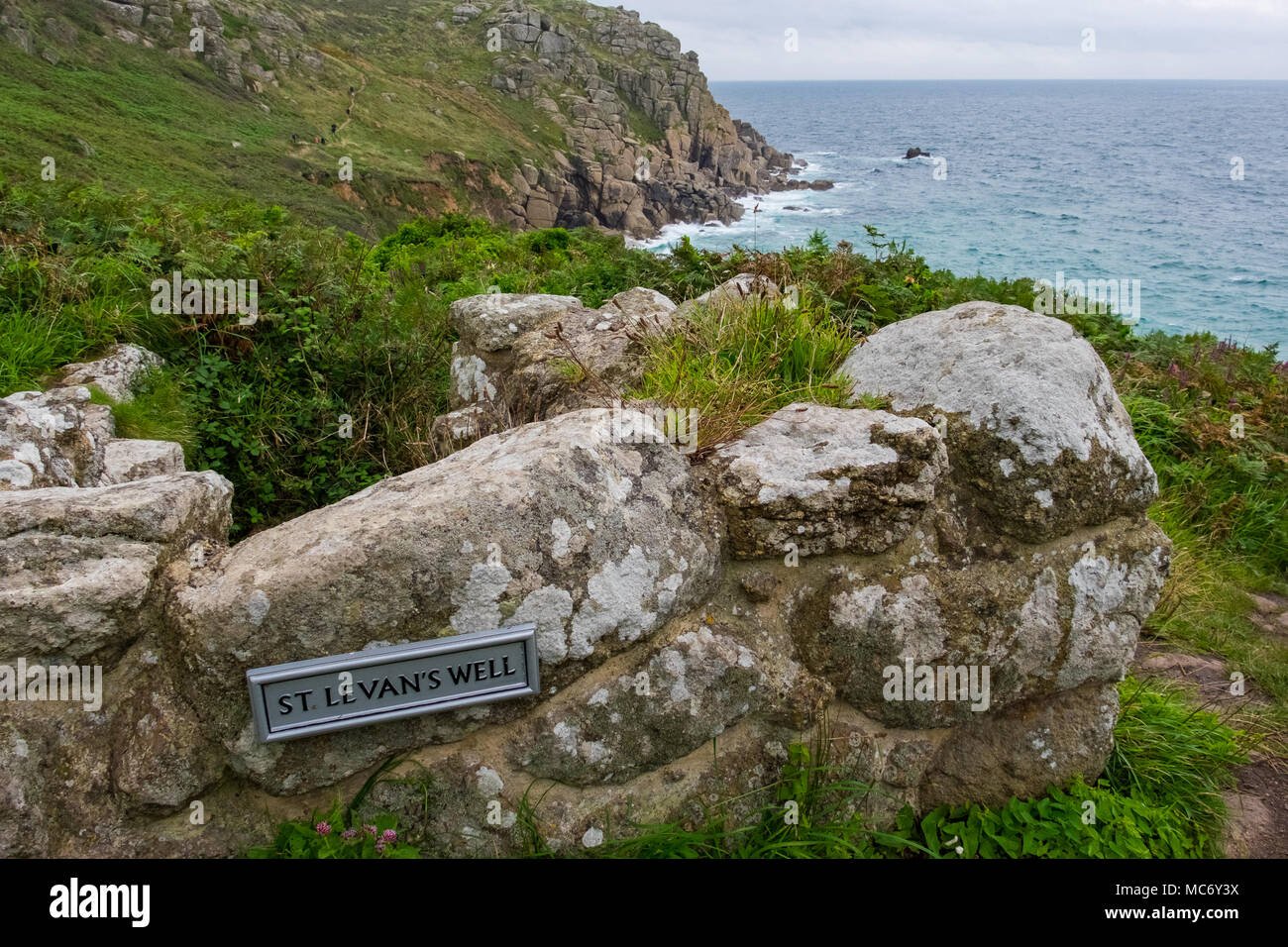 View towards the sea and cliffs from the stones of St Levans Holy Well Stock Photo