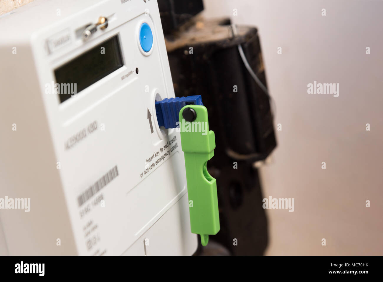 Topping up a pay as you go Mains electric digital prepaid card credit meter  with a key Stock Photo - Alamy