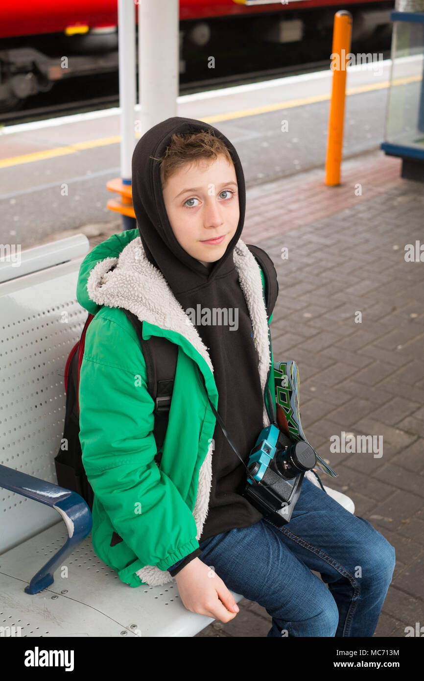 Eight year old boy waiting for a train at Guildford train station