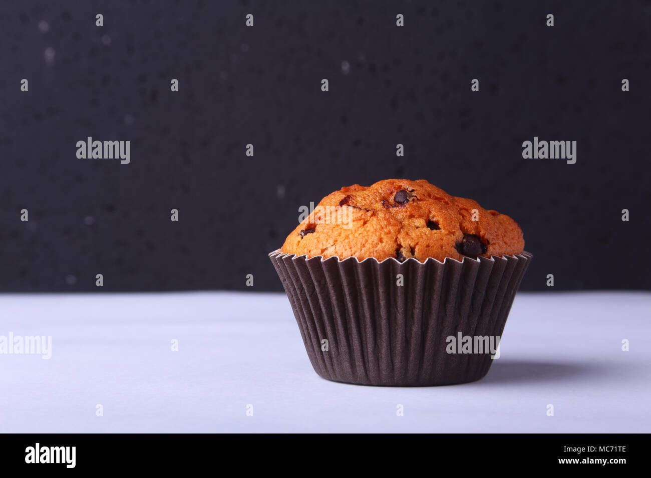 Tasty chocolate cupcakes, muffins on a white wooden table. Stock Photo
