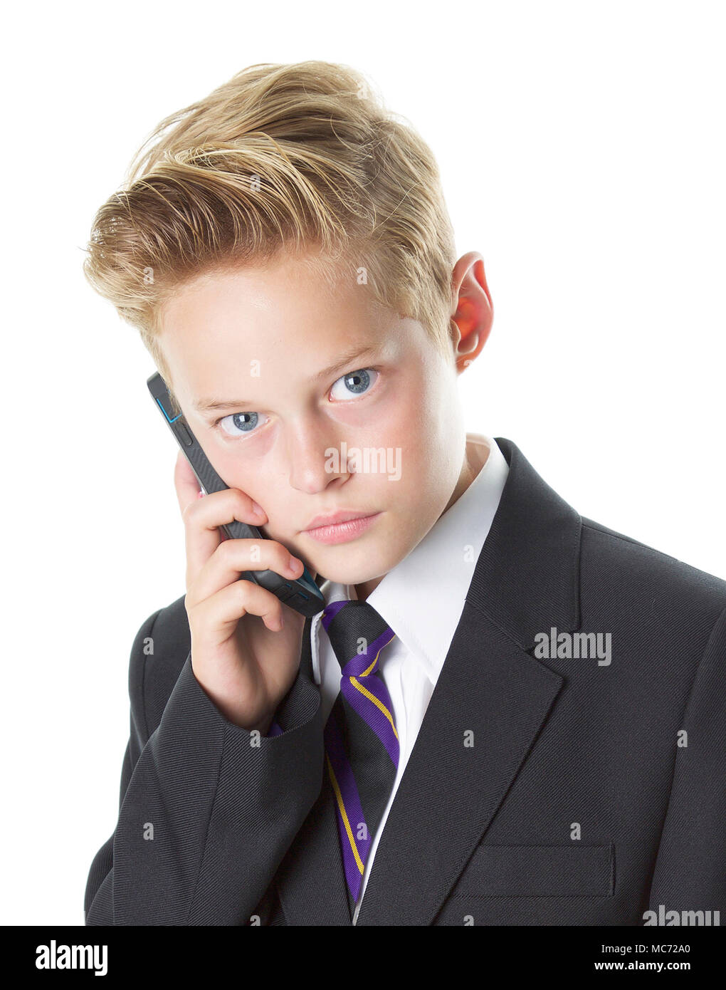 School boy in uniform on mobile phone Stock Photo