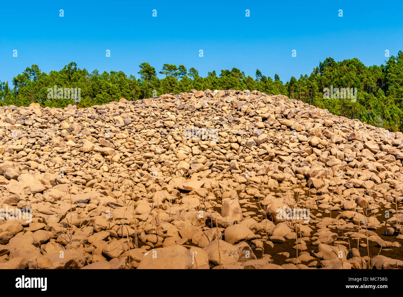 grey wall of round stones Stock Photo