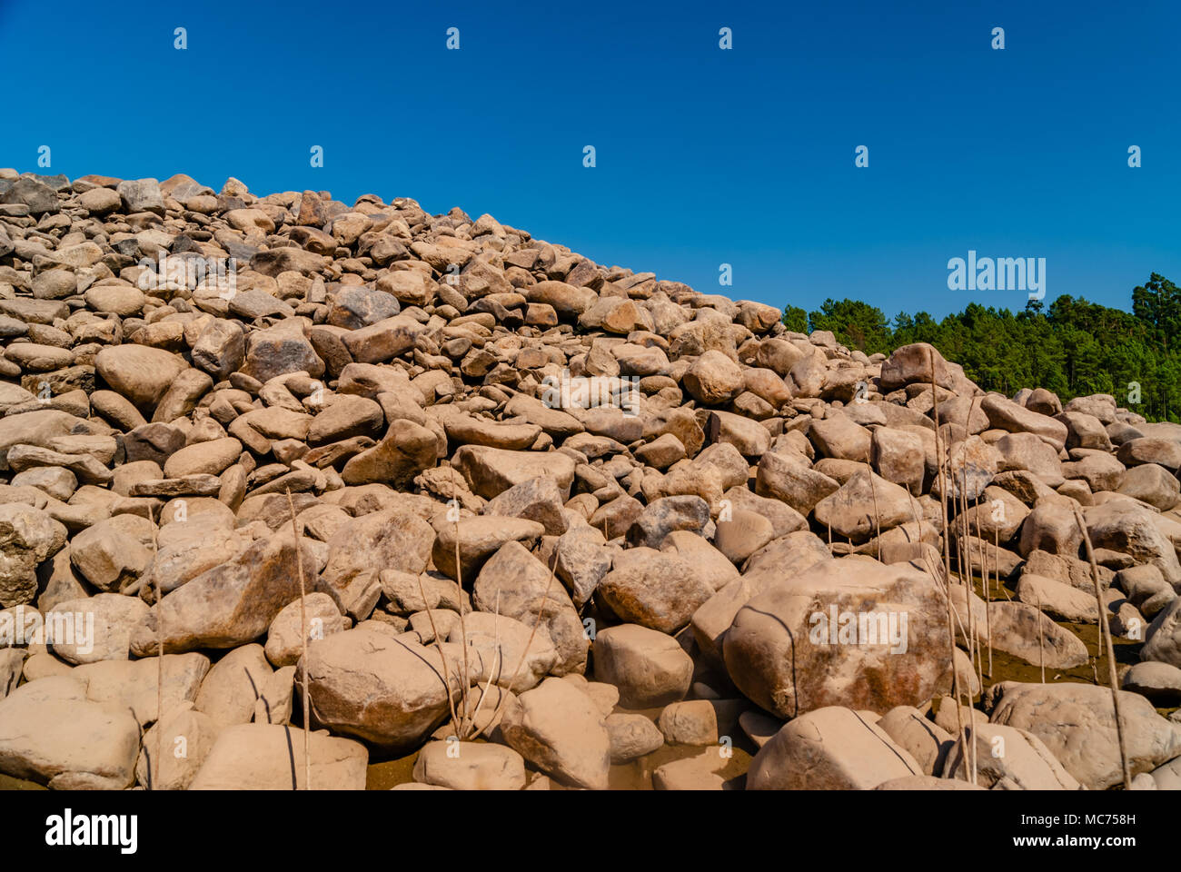 grey wall of round stones Stock Photo