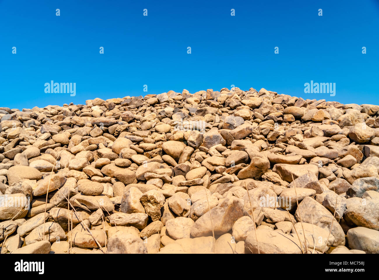 grey wall of round stones Stock Photo