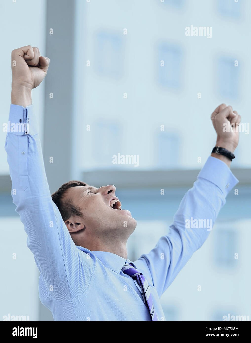 Businessman celebrating with his fists raised in the air Stock Photo ...