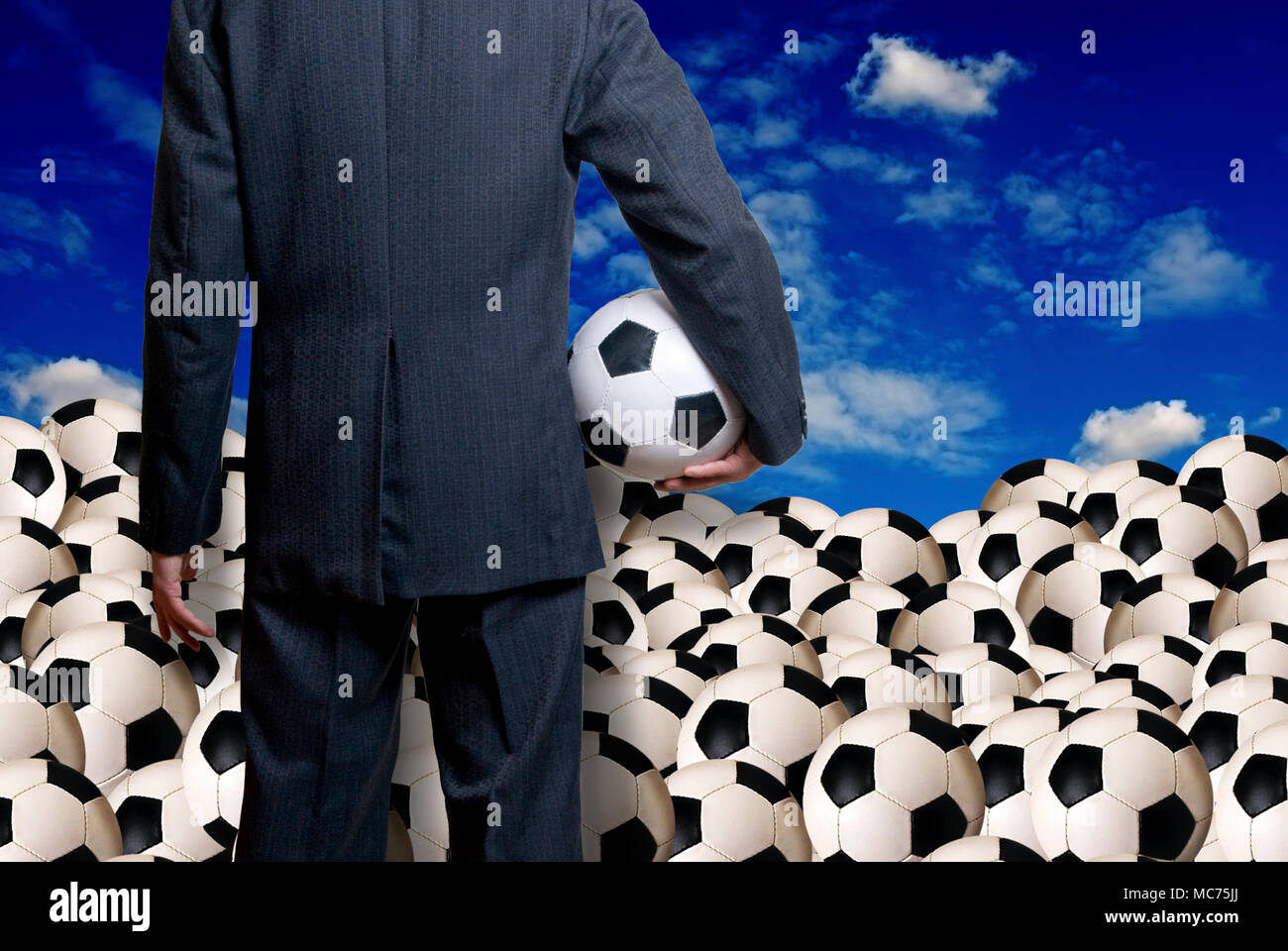 man in suit standing and holding a soccer ball Stock Photo - Alamy