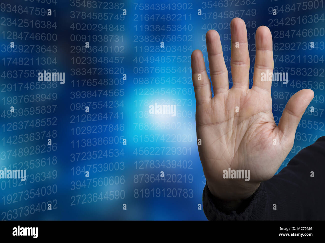 open hand in halt gesture, with data numbers in background Stock Photo