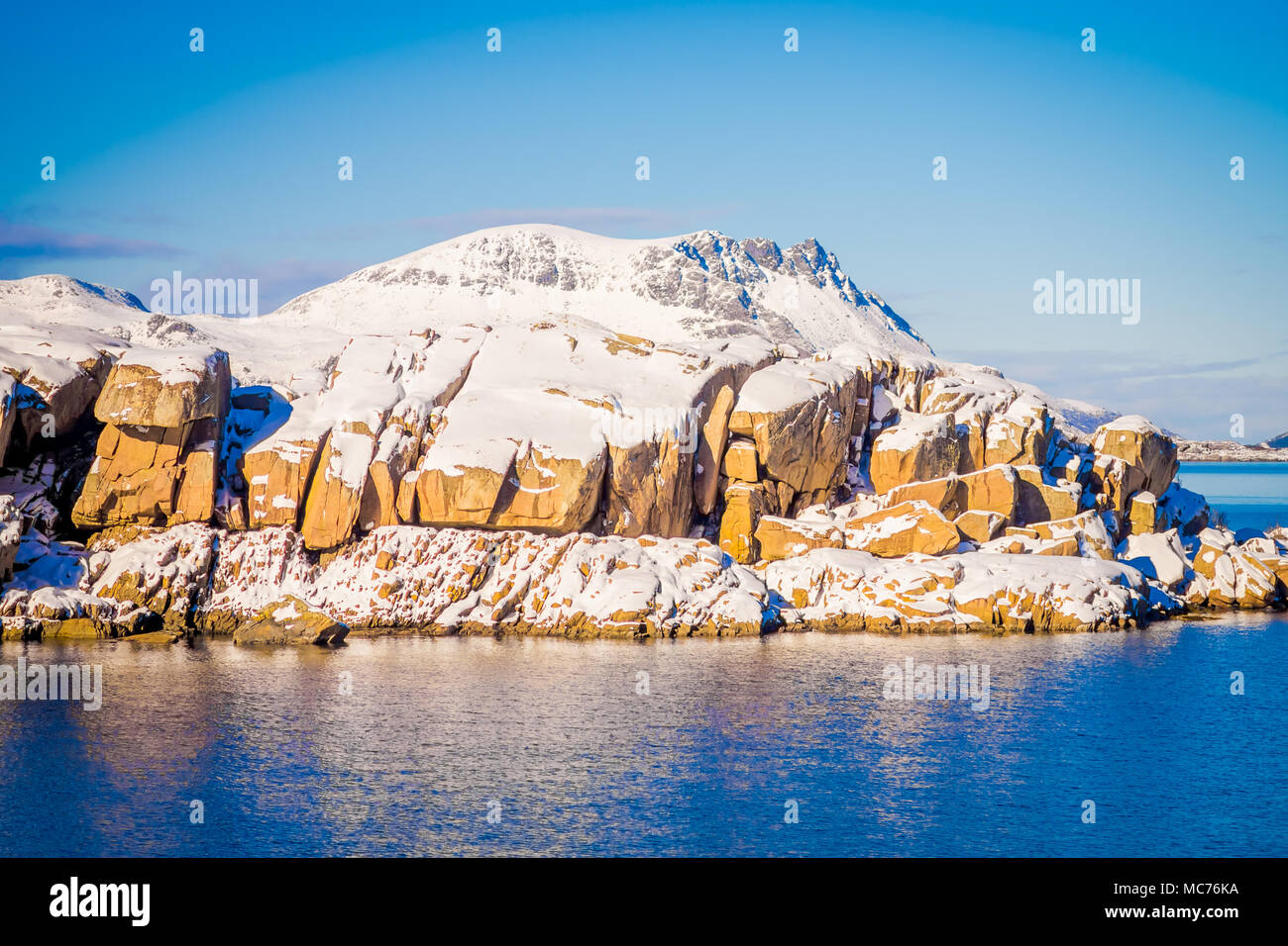 Outdoor View Of Snowy Rock Mountain Covered During Winter In The Arctic Circle In A Gorgeous Blue Sky And Blue Water Stock Photo Alamy Outdoor View Of Snowy Rock Mountain Covered During Winter In The Arctic Circle In A Gorgeous Blue Sky And Blue Water Stock Photo Alamy