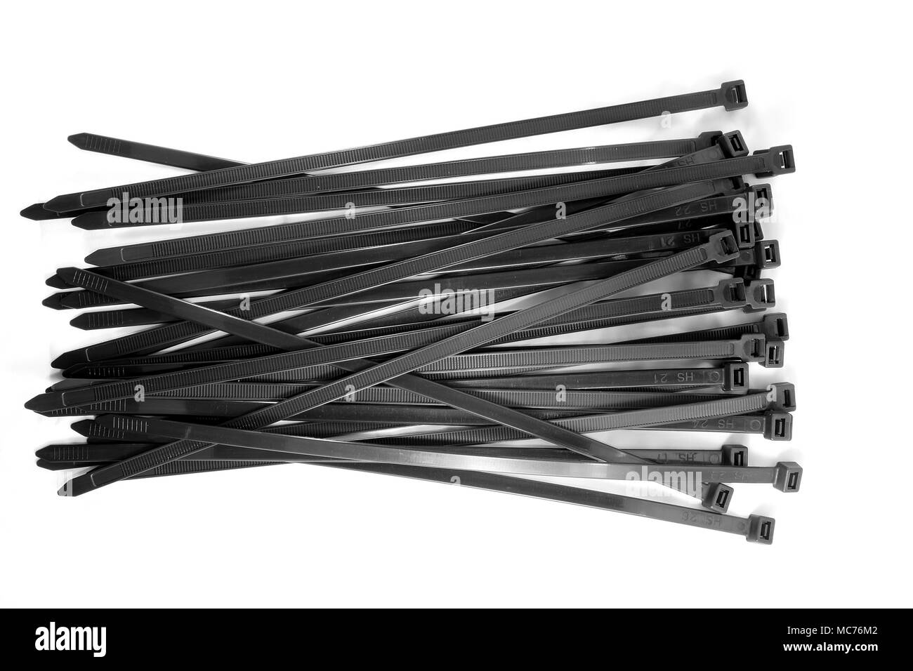 Many black cable tie on white background. Stock Photo