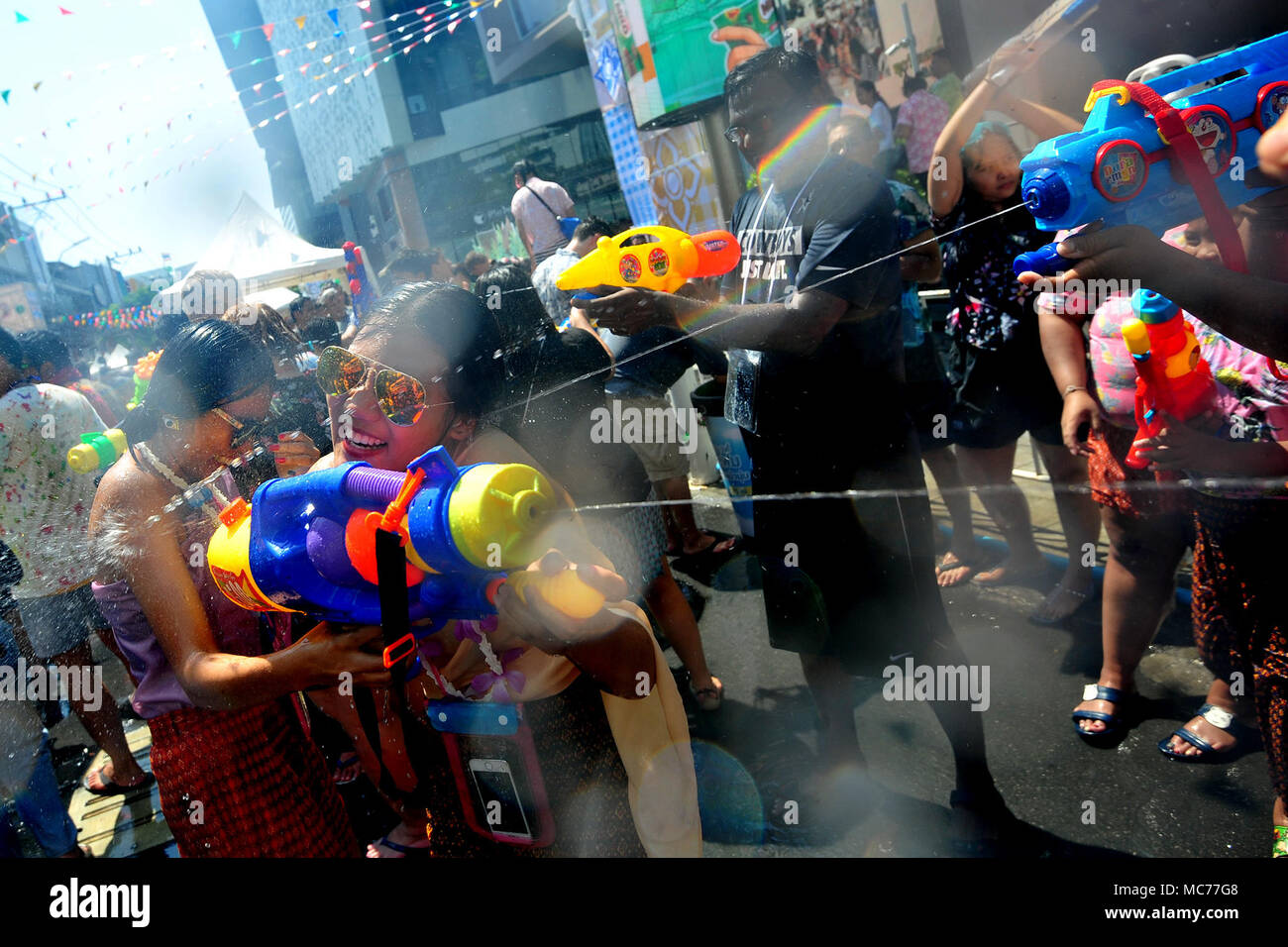 Bangkok, Thailand. 13th Apr, 2018. People take part in water gun battles during celebrations for Songkran Festival, Thailand's traditional New Year Festival, in Siam shopping district of Bangkok, Thailand, April 13, 2018. Credit: Rachen Sageamsak/Xinhua/Alamy Live News Stock Photo
