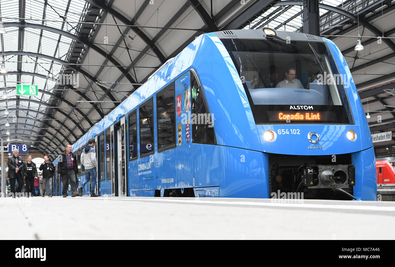 13 April 2018, Germany, Wiesbaden: passengers board a fuel cell-powered communter train of French manufacturer Alstrom at the train station. The regional transport association 'Rhein-Main-Verkehrsverbund' wants to replace diesel train engines which have been servicing four not electrified secondary lines in the Taunus region. Photo: Arne Dedert/dpa Stock Photo