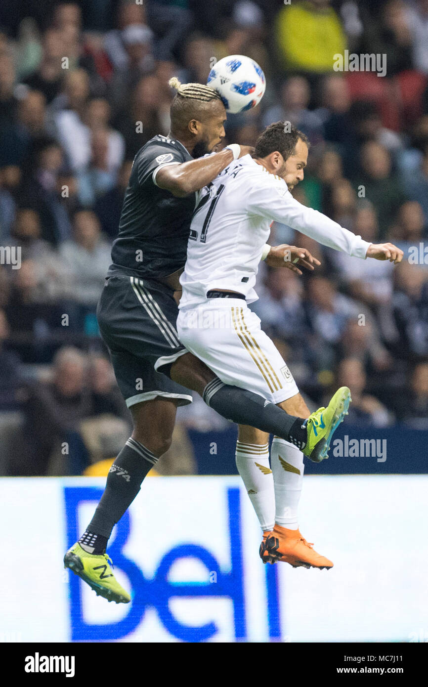 Vancouver, Canada. 13 April 2018. Vancouver Whitecaps defender Kendall Waston (4), and Los Angeles FC forward Marco Urena (21) jumping for the ball. LAFC wins 2-0.  Vancouver Whitecaps vs LAFC BC Place.  © Gerry Rousseau/Alamy Live News Stock Photo