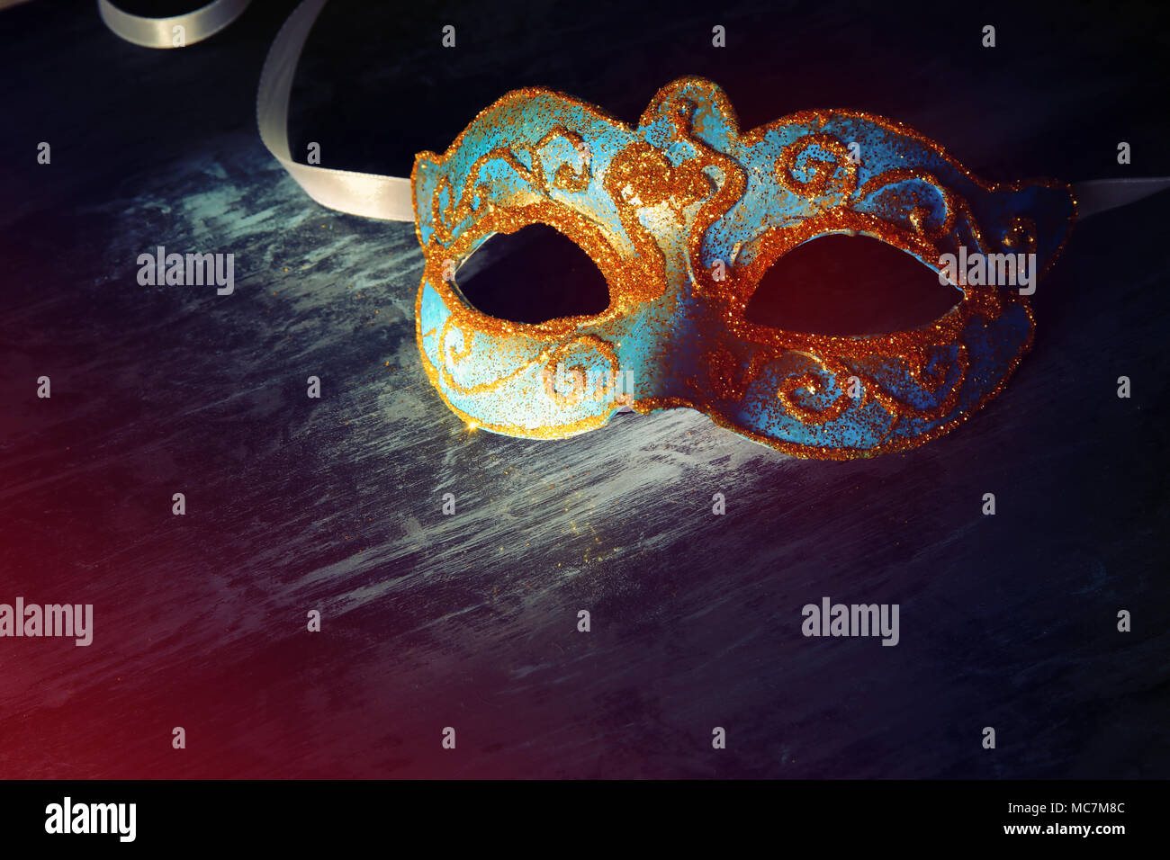 Image of elegant blue and gold venetian, mardi gras mask over black