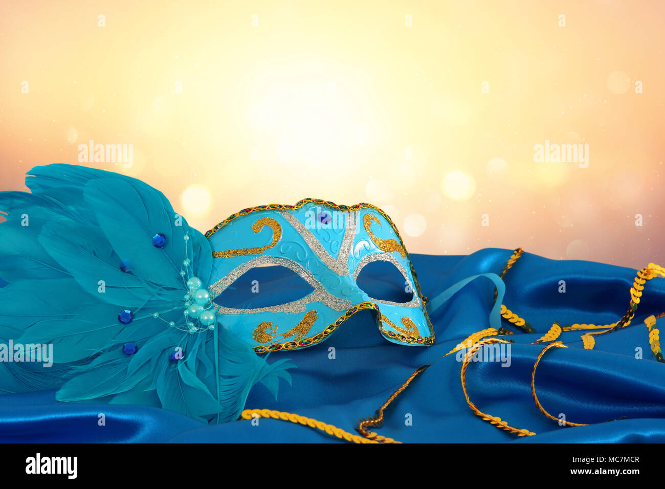 Image of elegant blue and gold venetian mask over blue silk fabric ...