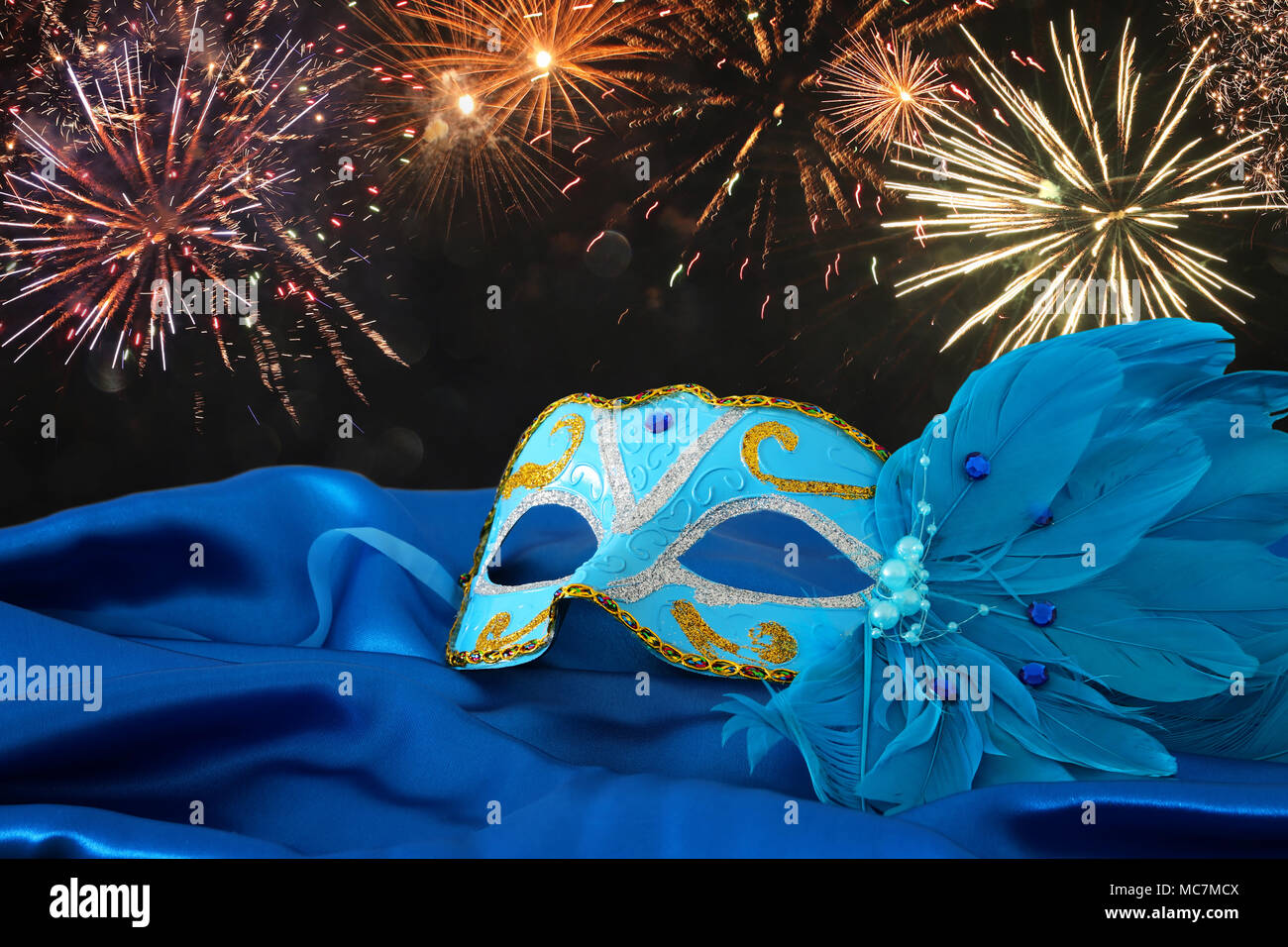Image of elegant blue and gold venetian mask over blue silk fabric ...