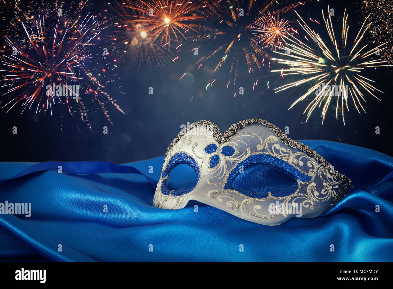 Image of elegant blue and gold venetian mask over blue silk fabric ...