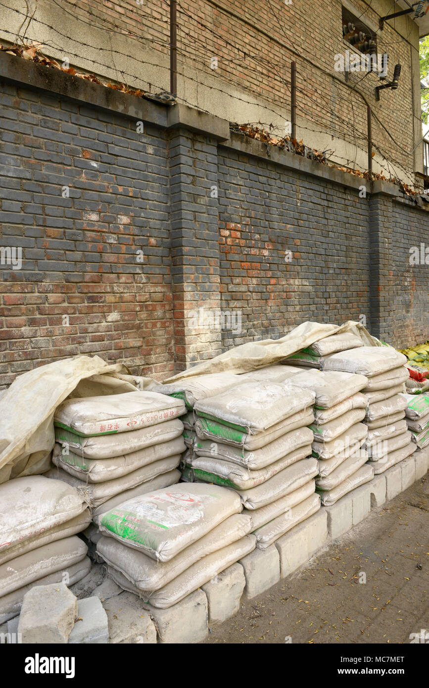 Bags of cement stored near a building site for use in local smallscale