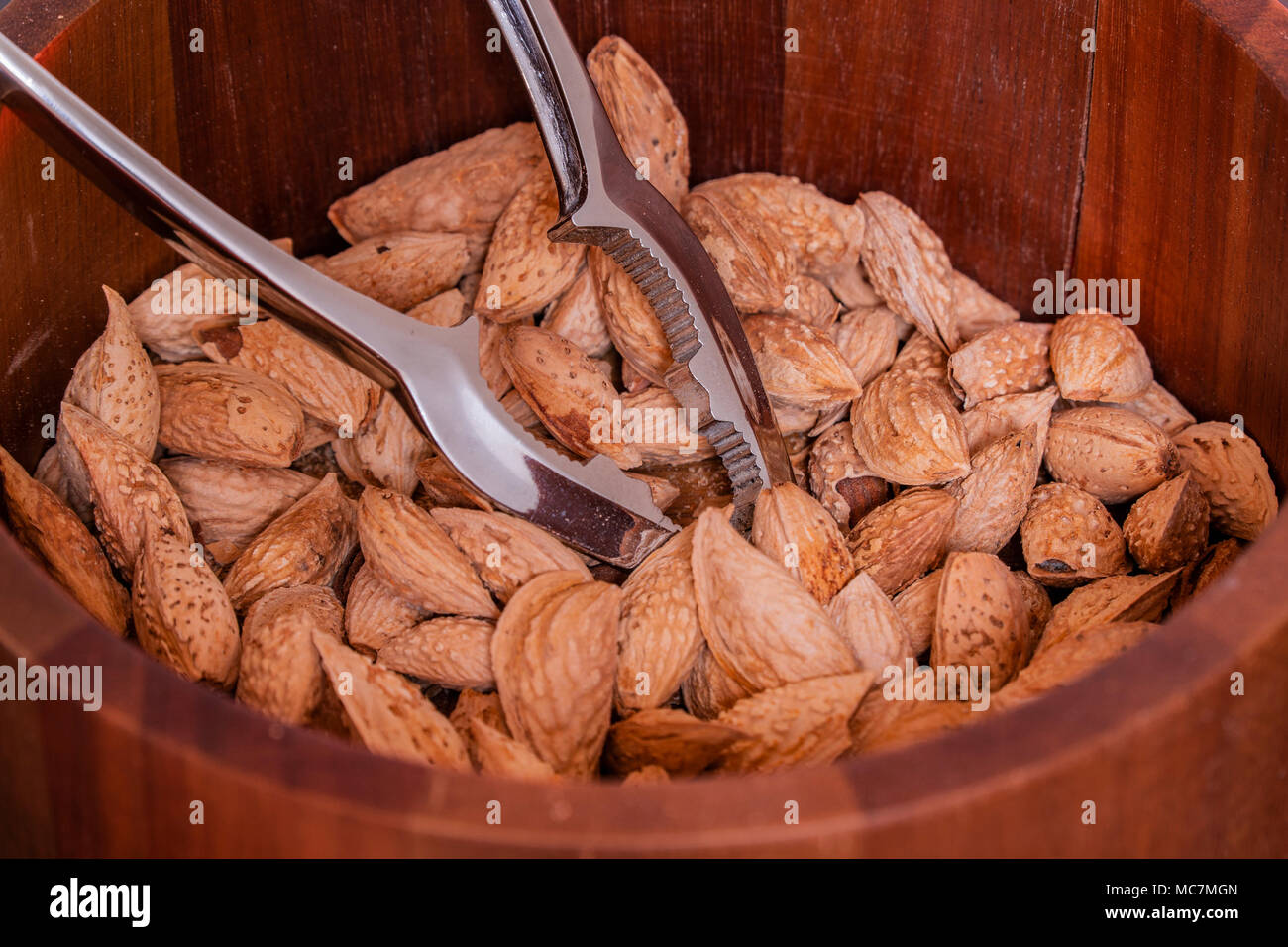 Almonds in a wooden bowl for healthy eating Stock Photo