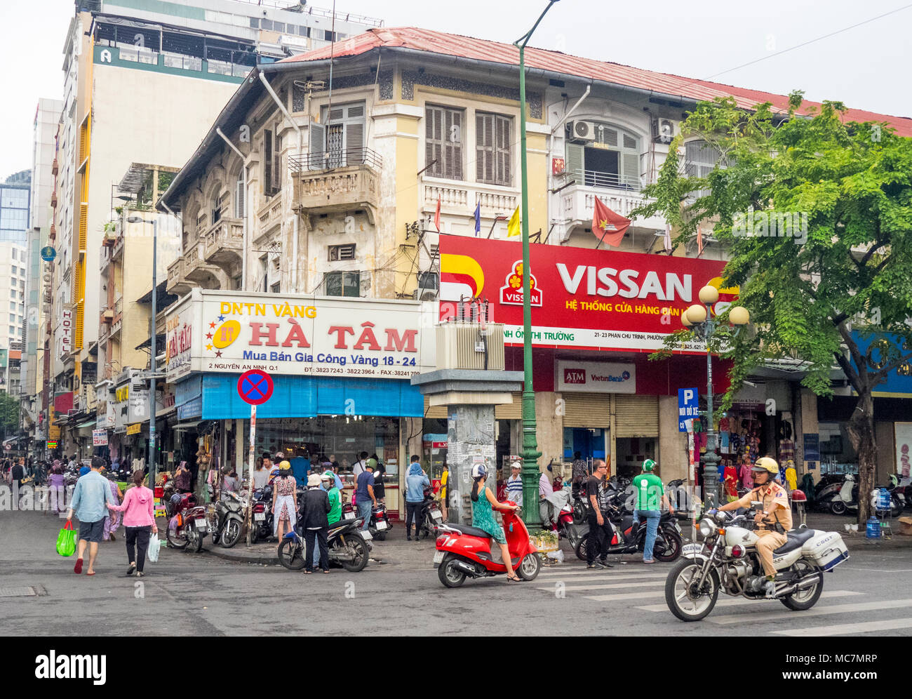Billboards hiding french colonial architecture on a busy intersection near the Ben Thanh markets, in Ho Chi Minh City, Vietnam. Stock Photo